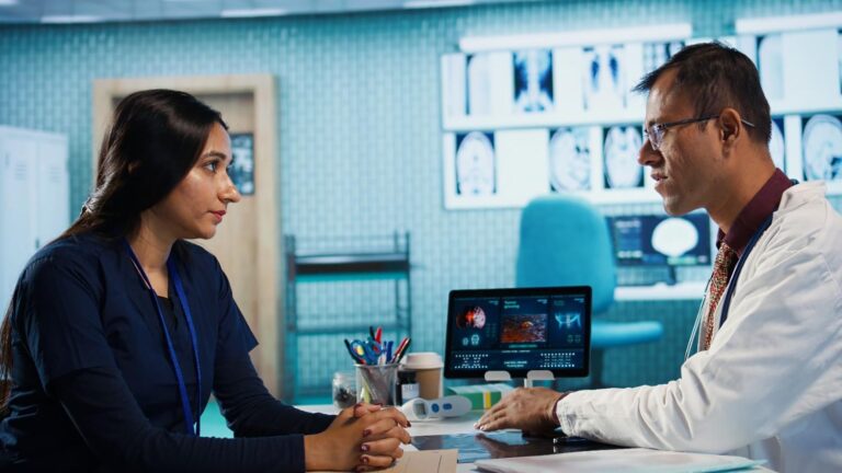 Doctor analyzing healthcare marketing strategy on a digital dashboard to overcome challenges in online visibility and patient trust.